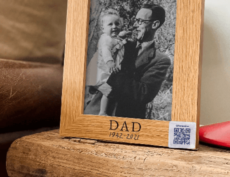 Home memorial tag placed near a frame or memorial display